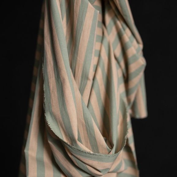 Striped, organic cotton, linen fabric with pink and green pattern on a black background