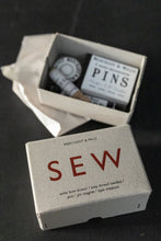 Load image into Gallery viewer, Cardboard box with &quot;sew&quot; printed on, next to box of various haberdashery tools
