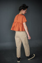 Load image into Gallery viewer, Lady walks wearing tapered trousers with a flounce top
