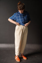 Load image into Gallery viewer, Lady wears peg trousers with angled pockets and turn ups
