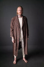 Load image into Gallery viewer, Model stands, wearing the Sunday: a traditional dressing gown with shawl collar, worn unfastened.
