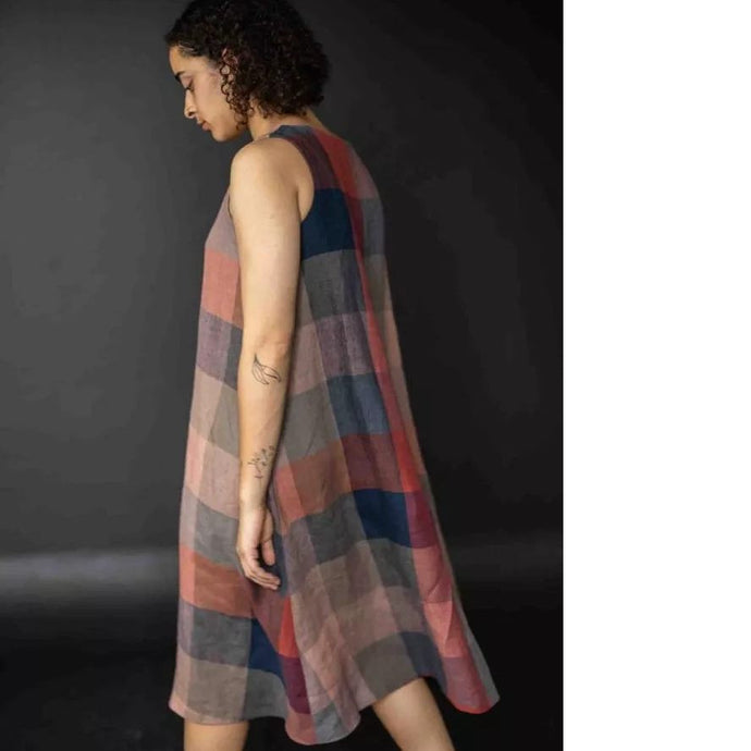 Back/side view of model walking, wearing the Trapeze dress