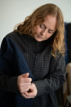 Load image into Gallery viewer, Model wears a grandad-collar shirt dress, putting on a jacket
