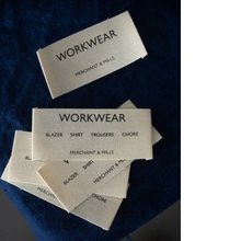 Load image into Gallery viewer, Workwear cotton labels from Merchant &amp; Mills on denim fabric background
