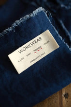 Load image into Gallery viewer, Cotton label on a denim garment with 'Workwear' text
