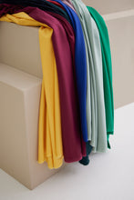 Load image into Gallery viewer, EcoVero Viscose Leia Crepe Fabric in various colours lay in a pile on each other
