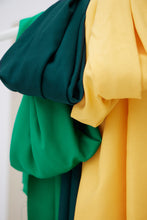 Load image into Gallery viewer, Three colours of EcoVero Viscose Leia Crepe Fabric hangs together over a rod
