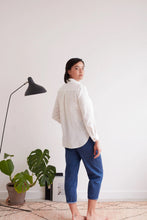 Load image into Gallery viewer, Back view of model wearing a collared shirt, with inverted pleat at centre of yoke
