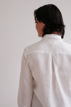 Load image into Gallery viewer, Close up of back view of model wearing collared shirt with inverted pleat at centre of yoke
