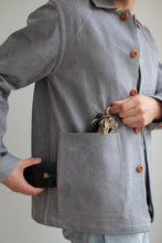 Load image into Gallery viewer, Close-up detail of Jaime Jacket patch pocket detail with model holding keys at the top opening of patch pocket, and a phone into the side opening of the pocket
