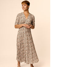 Load image into Gallery viewer, Lady stands wearing a V-neck button closing mid-calf length dress. Half sleeves
