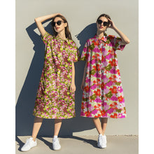 Load image into Gallery viewer, Two models wears shirt dresses made up in Eco Viscose fabric with a bold, retro-style floral pattern, in different colourways
