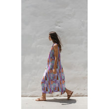 Load image into Gallery viewer, Model wears a long sleeveless dress made with Shape Shifter Viscose Fabric
