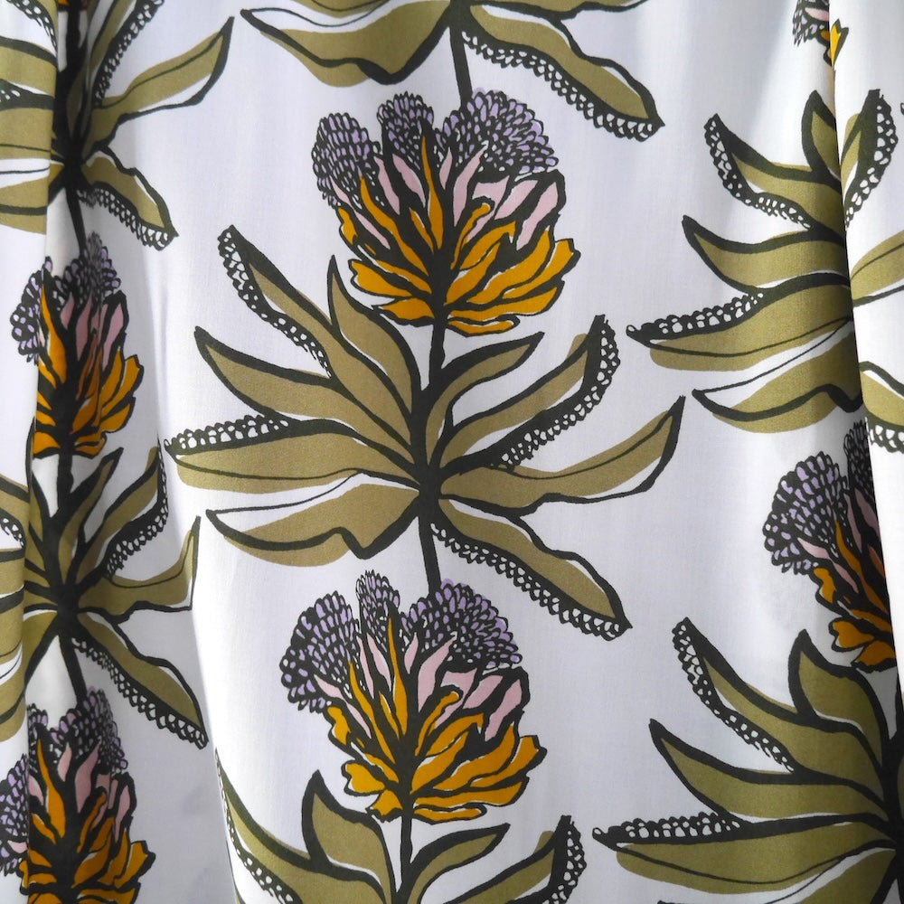 EcoVero Viscose fabric hangs with floral stem print, repeat pattern.