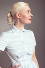 Load image into Gallery viewer, Lady wears a short sleeve button up shirt with rounded collar, with waist to bust darts
