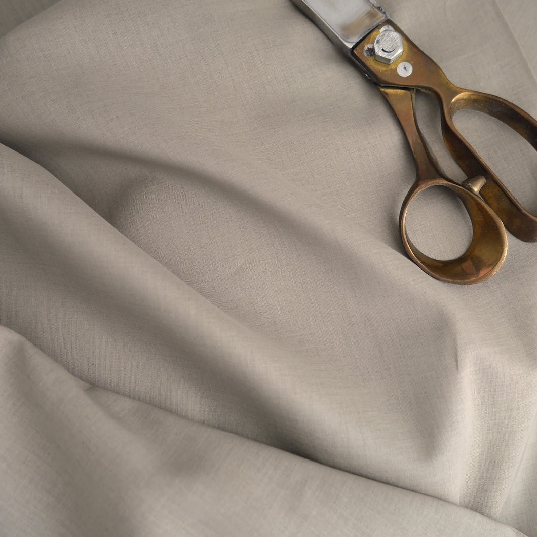 Organic Cotton Voile Fabric displayed with a pair of scissors