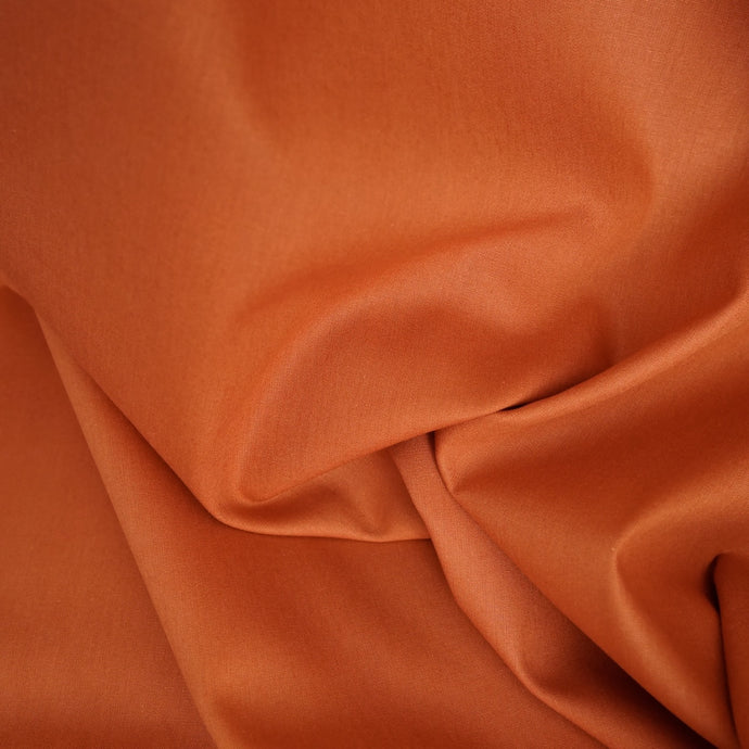 Organic cotton poplin fabric shown slightly crumpled