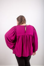 Load image into Gallery viewer, Back view of model wearing a long voluminous sleeve, and gathered detail at yoke with centre back ribbon fastening.

