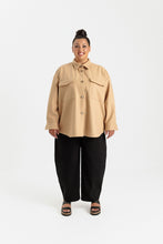 Load image into Gallery viewer, Lady wears a long sleeved, button up shirt with patch pockets at chest
