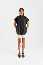 Load image into Gallery viewer, Lady wears a short sleeved, button up shirt with patch pockets at chest
