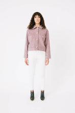 Load image into Gallery viewer, Lady wears Papercut Stacker Jacket pattern, a utility jacket with large patch pockets on front. Worn fastened up with four large buttons
