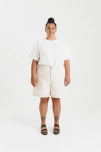 Load image into Gallery viewer, Lady wears Sera Shorts with utilitarian-style patch pockets 
