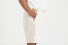 Load image into Gallery viewer, Close up detail of side view of Sera Shorts with utilitarian-style patch pockets at front. and patch pocket at back
