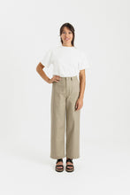 Load image into Gallery viewer, Lady wears straight leg trousers with utilitarian-style patch pockets at hip level
