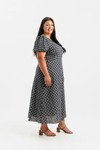 Load image into Gallery viewer, Side profile of lady wearing a short sleeve dress with bias cut skirt, midi length
