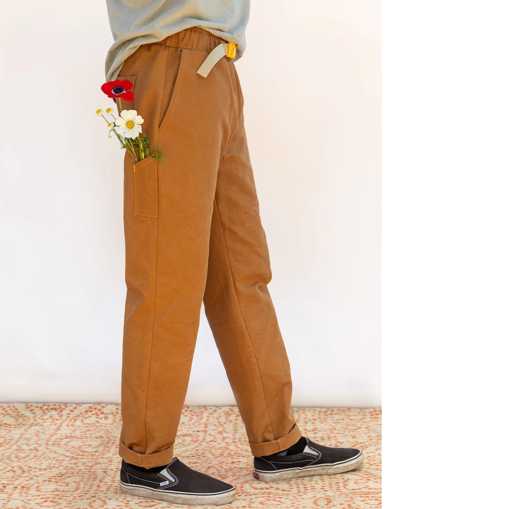 Side view close up of person wearing Rambler Pants: tapered trouser with slant side pocket and small long patch pocket at side