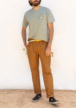 Load image into Gallery viewer, Model wears Rambler Pants; tapered trousers with turn up, and patch pockets at sides
