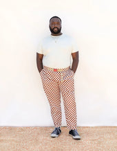 Load image into Gallery viewer, Model wears Rambler Pants in chequered pattern fabric
