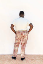 Load image into Gallery viewer, Back view of model wearing Rambler Pants in a chequered fabric print
