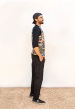 Load image into Gallery viewer, Side view of model wearing Rambler Pants, hand in pocket, above the utilitarian patch pocket on the side seam
