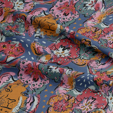 Load image into Gallery viewer, Find Your Tribe Organic Cotton Fabric shown with soft folds in drape, with a multicoloured pattern of outlines of tigers, hares, snails and flower heads
