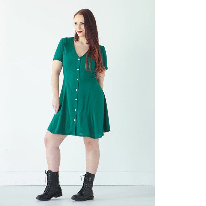 Lady wears The Shelby Dress, a princess seamed V neck button front dress, short sleeve, above knee length