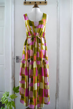 Load image into Gallery viewer, Sleeveless dress with tie waist, and gathered tier maxi dress, made with Shape Shifter Viscose fabric, displayed on mannequin
