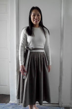 Load image into Gallery viewer, Lady wears a pleated Hanbok Wrap Skirt made with Stone Washed Linen fabric
