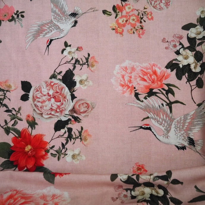 Viscose Fabric with oversized blooms amongst storks mid-flight pattern, displayed with drape