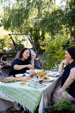 Load image into Gallery viewer, Two ladies chatting and eating at a picnic table wearing gathered neckline blouses
