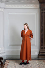 Load image into Gallery viewer, Front view of model wearing a full length dress, with scalloped deep V-neckline, and short puffy sleeves
