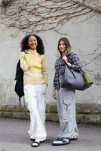 Load image into Gallery viewer, Two ladies carrying bags wearing cargo style trousers.
