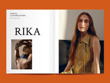 Load image into Gallery viewer, Magazine spread features the title &quot;Rika&quot; alongside a photo of a lady sat wearing a pointed collar, sleeveless shirt with pleated bodice front
