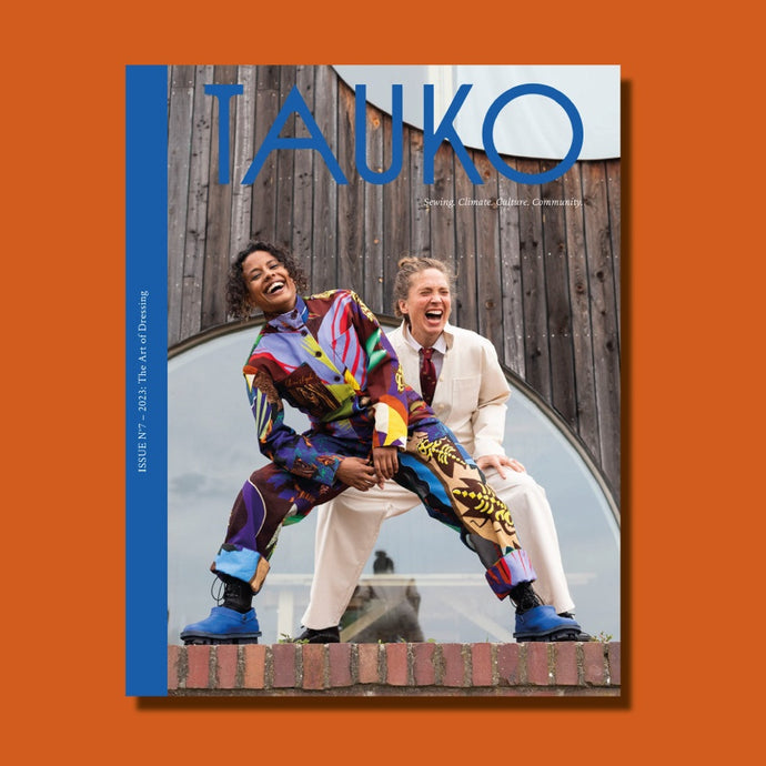 TAUKO magazine issue no 7 Cover features two ladies laughing, crouching, wearing jumpsuits