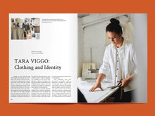Load image into Gallery viewer, Magazine spread features article titled: &quot;Tara Viggo: Clothing and Identity&quot; alongside photo of lady cutting some fabric
