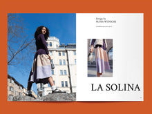 Load image into Gallery viewer, Magazine spread features photo of lady wearing a tiered skirt, alongside title: &quot;La Solina&quot;.

