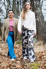 Load image into Gallery viewer, Two ladies wearing straight legged trousers strolling amongst trees
