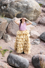 Load image into Gallery viewer, Model stands amongst rocks wearing a layered/tiered volumised ruffle skirt
