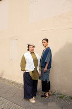 Load image into Gallery viewer, Two ladies stand by wall wearing long, elbow length sleeve shirts with a waistcoat jacket over the top.
