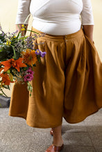 Load image into Gallery viewer, Lady wears wide legged culottes, pleated at the waistband
